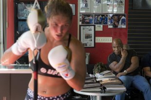 Mike Tyson, right, watches as Ronda Rousey, works out at Glendale Fighting Club. (AP)