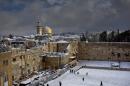 Western Wall and the Dome of the Rock, some of the holiest sites for for Jews and Muslims, are covered in snow in Jerusalem, Friday, Dec. 13, 2013. Early snow has surprised many Israelis and Palestinians as a blustery storm, dubbed Alexa, brought gusty winds, torrential rains and heavy snowfall to parts of the Middle East. (AP Photo/Dusan Vranic)