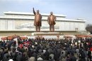 North Korean soldiers, workers and students place flowers before statues of Kim Il-sung and Kim Jong-il at Mansudae in Pyongyang