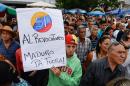 Anti-government demonstrators gather to sign a form to activate the referendum on cutting President Nicolas Maduro's term short, in Caracas on April 27, 2016