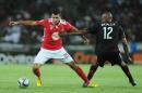 Orlando Pirates' Lehlogonolo Masalesa (R) vies with Etoile du Sahel's Mohamed Amine Ben Amor during the first final of the 2015 CAF - Confederation of African Football Cup match on November 21, 2015 at the Orlando Pirates Stadium in Johannesburg