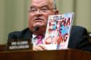 Long holds up a copy of a magazine with an Ebola headline as public health officials testify before a House Energy and Commerce Oversight and Investigations Subcommittee hearing on the U.S. response to the Ebola crisis, in Washington