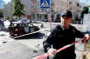 Police officer blocks off site where journalist Sheremet was killed by car bomb in Kiev