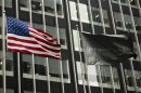 A U.S. and JPMorgan flag fly in front of the headquarters of JPMorgan Chase & Co bank in New York