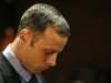 FILE - In this Feb. 21, 2013 file photo, Olympic athlete Oscar Pistorius stands during his bail hearing at the magistrate court in Pretoria, South Africa.Pistorius has been spending time with people who were close to the girlfriend he shot and killed on Valentine's Day, the Olympian's family said Thursday, April 11, 2013 in an indication that Pistorius is becoming more active while awaiting trial on a murder charge. (AP Photo/Themba Hadebe, File)