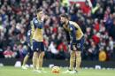 Arsenal's Mesut Ozil, left and teammate Arsenal's Olivier Giroud wait in the centre circle to restart the game after manchester United scored their third goal during the English Premier League soccer match between Manchester United and Arsenal at Old Trafford Stadium, Manchester, England, Sunday, Feb. 28, 2016.Man United won the game 3-2. (AP Photo/Jon Super)