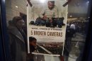 A poster for the Oscar-nominated documentary "5 Broken Cameras" is displayed in Ramallah