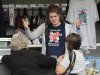 A member of staff talks to customers at a London 2012 shop selling official merchandise in Green Park, central London