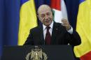 Romania's President Basescu gestures as he speaks during a joint news conference with Palestinian President Abbas in Ramallah