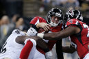 Atlanta Falcons quarterback Matt Ryan, center, is sacked by New Orleans Saints defensive end Tyrunn Walker, left, in the first half of an NFL football game in New Orleans, Sunday, Sept. 8, 2013. (AP Photo/Bill Haber)