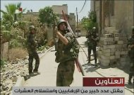An image grab taken from footage broadcast by Syrian state TV on July 22, 2012 purportedly shows Syrian security forces combing through Basatin al-Razi, a dictrict of the capital Damascus. Regime forces used helicopter gunships Sunday in a new assault on rebels in Damascus, activists said. (AFP Photo/)