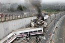 In this photo taken on Wednesday July 24 2013, Emergency personnel respond to the scene of a train derailment in Santiago de Compostela, Spain. Police say they have detained the driver of a train that crashed in northwestern Spain and killed 78 people. Galicia region National Police Chief Jaime Iglesias says driver Francisco Jose Garzon Amo was officially detained in the hospital where is recovering. (AP Photo/La Voz de Galicia/Monica Ferreiros)