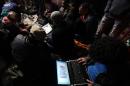 Egyptian anti-government bloggers work on their laptops from Cairo's Tahrir square on February 10, 2011