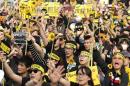 Demonstrators holding sunflowers shout slogans in front of the Presidential Office in Taipei