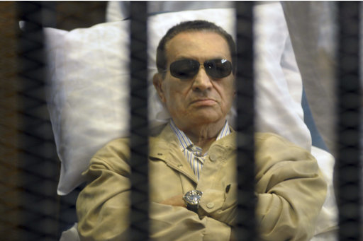 Egypt's ex-President Hosni Mubarak lays on a gurney inside a barred cage in the police academy courthouse in Cairo, Egypt, Saturday, June 2, 2012. Mubarak was sentenced to life in prison Saturday for his role in the killing of protesters during last year's revolution that forced him from power, a verdict that caps a stunning fall from grace for a man who ruled the country as his personal fiefdom for nearly three decades.(AP Photo)
