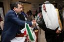 Secretary General of Organisation of Islamic Cooperation (OIC) Saudi Iyad Ameen Madani (R) shakes hands with Iran's Deputy Foreign Minister Abbas Araghchi during an emergency meeting in the Saudi city of Jeddah, on January 21, 2016