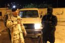 Libyan security forces members man a security checkpoint on November 8, 2013 in the eastern Benghazi city