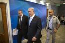 Israel's Prime Minister Benjamin Netanyahu, center, arrives to the weekly cabinet meeting at his office in Jerusalem, Sunday, June 22, 2014. Israel's military says troops have shot dead one Palestinian, and a Palestinian medical official says another was killed, as the army searches for three missing teens and looks to dismantle the Islamic militant group Hamas. Meanwhile the military says a civilian vehicle has exploded near the Syrian frontier in the Golan Heights, and that there are several casualties. (AP Photo/Baz Ratner, Pool)