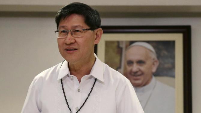 FILE - In this July 29, 2014 file photo, Manila Archbishop Cardinal Luis Antonio Tagle prepares for a simultaneous announcement with the Vatican on the five-day Apostolic visit of Pope Francis to the Philippines in mid-January in 2015, in Manila, Philippines. Pope Francis will be welcomed in the Catholic heartland on Thursday, Jan. 15, 2015, by the Filipino cardinal who might one day succeed him: a boyish-looking priest who rode the bus as a bishop and has impressed many with a humble life, intellect and compassion for the poor. (AP Photo/Bullit Marquez, File)
