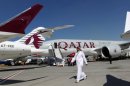 An Emirati man walks past Qatar Airways planes in 2011