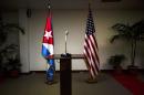 FILE - In this Jan. 22, 2015 file photo, a Cuban and U.S. flag stand before the start of a press conference on the sidelines of talks between the two nations in Havana, Cuba. The U.S. hopes to open an embassy in Havana before presidents Barack Obama and Raul Castro meet at a regional summit in April, which will be the scene of the presidents' first face-to-face meeting since they announced on Dec. 17 that they will re-establish diplomatic relations after a half-century of hostility. (AP Photo/Ramon Espinosa, File)