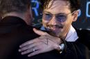 Actor Johnny Depp, with a diamond ring on his left hand, attends a promotional event for his new movie 