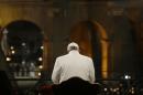 Pope Francis prays in front of the Colosseum at the start of the Via Crucis (Way of the Cross) torchlight procession celebrated by Pope Francis on Good Friday in Rome, Friday, April 3, 2015. (AP Photo/Gregorio Borgia)