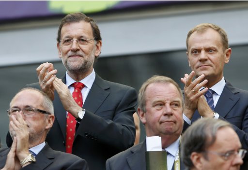 Spain's Prime Minister Rajoy applauds next to Poland's Prime Minister Tusk at the start of their Group C Euro 2012 soccer match between Spain and Italy in Gdansk