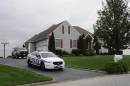 A Suffolk County Police car is stationed in the driveway of the home of Shoreham-Wading River High School junior Tom Cutinella, Thursday, Oct. 2, 2014, in Shoreham, N.Y. Authorities say Cutinella, a 16-year-old football player at the high school, died at a hospital the night before after suffering a head injury in an on-field collision during a game with John Glenn High School in Elwood, N.Y. (AP Photo/Kathy Kmonicek)