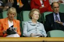 FILE - In this July 2, 2005, file photo, former British Prime Minister Margaret Thatcher, center, watches a seminfinal between Andy Roddick and Thomas Johansson on Centre Court at Wimbledon. At left is Thatcher's daughter Carol Thatcher and at right is General Sir Mike Jackson. The office of prime minister changed hands 16 times between Wimbledon titles for Fred Perry and Andy Murray. (AP Photo/Anja Niedringhaus, File)