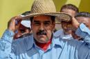 Venezuelan President Nicolas Maduro wears a hat during a rally in Caracas on May 31, 2016