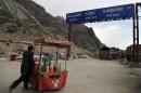 An Afghan street vendor crosses the border between Pakistan and Afghanistan through Torkham Gate at Torkham on May 20, 2012