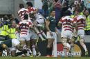 Japan players celebrate the match winning try by Karne Hesketh during the Rugby World Cup Pool B match between South Africa and Japan at the Brighton Community Stadium, Brighton, England Saturday, Sept. 19, 2015. (AP Photo/Tim Ireland)