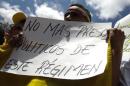 A supporter of Ledezma holds a banner during a gathering in support of him in Caracas
