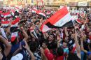 Demonstrators chant in support of Iraqi Prime Minister Haider al-Abadi as they wave national flags during a demonstration in Tahrir Square in Baghdad, Iraq, Friday, Aug. 14,2015. Thousands of people demonstrated in cities across Iraq on Friday to show support for a reform plan put forth by the prime minister this week while still demanding that greater measures be taken to target corruption and restore basic services. (AP Photo/Karim Kadim)