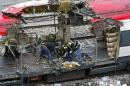 Forensic experts inspect the train which exploded at the Atocha train station March 11, 2004