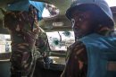 UNAMID military personnel from Tanzania drive at their base in one of the APC that was damaged after being ambushed yesterday, in Khor Abeche