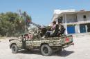 Libyan forces ride a military vehicle as they prepare for next advance against Islamic State holdouts in Sirte