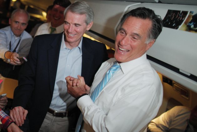 Republican presidential candidate and former Massachusetts Gov. Mitt Romney and Sen. Rob Portman, R-Ohio, talk to reporters on board the campaign charter plane as it flies to Bedford,   Mass.,
 Friday,
 Sept. 14,
 2012. (AP Photo/Charles Dharapak)