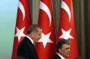 Turkey's new President Tayyip Erdogan and outgoing President Abdullah Gul, attend a handover ceremony at the Presidential Palace of Cankaya in Ankara