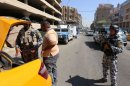 Iraqi security forces search a taxi cab at a mobile checkpoint in central Baghdad on August 27, 2013
