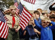 FILE - In this Feb. 6, 2013 file photo, from left, Joshua Kusterer, 12, Nach Mitschke, 6, and Wyatt Mitschke, 4, salute as they recite the pledge of allegiance during the “Save Our Scouts” prayer vigil and rally against allowing gays in the organization in front of the Boy Scouts of America National Headquarters in Dallas, Texas. Under pressure over its long-standing ban on gays, the BSA announced Friday, April 19, 2013, that it will submit a proposal to its National Council to lift the ban for youth members but continue to exclude gays as adult leaders. (AP Photo/Richard Rodriguez, File)