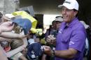 Phil Mickelson signs autographs for fans following his third round of the Memorial golf tournament Saturday, May 31, 2014, in Dublin, Ohio. (AP Photo/Darron Cummings)