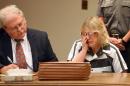 Joyce Mitchell cries as she sits with her attorney Stephen Johnston in court on Tuesday July 28, 2015 in Plattsburgh, N.Y. Mitchell, an instructor in the tailor shop at the Clinton Correctional Facility, pleaded guilty to charges of aiding two inmates convicted of murder by smuggling hacksaw blades and other tools to the pair, who broke out and spent three weeks on the run in June. She faces a sentence of 2 1/3 to 7 years in prison under terms of a plea deal with prosecutors. (Rob Fountain/The Press-Republican via AP, Pool)