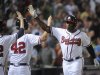 Atlanta Braves' Justin Upton, right, is congratulated as he comes back to the dugout after a home run against the Kansas City Royals during the eighth  inning of a baseball game, Tuesday, April 16, 2013, in Atlanta. Atlanta won 6-3. (AP Photo/John Amis)