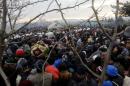 Refugees wait to cross the Greek-Macedonian border near the village of Idomeni