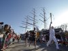 Sir Robin Knox Johnson, 73, right, runs with the Olympic torch past the Cutty Sark ship, Saturday, July 21, 2012, in Greenwich, London. The Olympic Torch arrived in London after it was carried around England in a relay of torchbearers to make its way to the London 2012 Olympic Games opening ceremony on July 27, 2012. (AP Photo/Jae C. Hong)