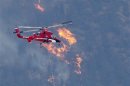 A firefighting helicopter approaches the Waldo Canyon fire in Colorado