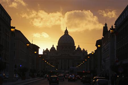 Saint Peter's Basilica at the Vatican is silhouetted during sunset in Rome, March 11, 2013. Roman Catholic Cardinals will begin their conclave inside the Vatican's Sistine Chapel Tuesday to elect a new pope. REUTERS/Paul Hanna
