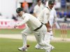Australia's Clark chases a mis-fielded ball as his captain Ponting looks on during the first Ashes cricket test match in Cardiff